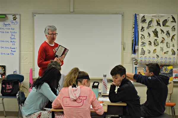 Children’s author Darlene Beck Jacobson works with students in Mr. Rogers’ class to hone their writing skills. 